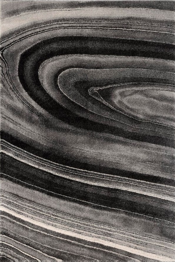 Picture of an area rug that has a vortex swirl on it in grey, black, and white